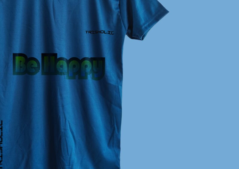 Plain back of matte blue t-shirt with styled “Be Happy” design on front