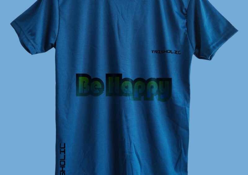Close-up of colorful “Be Happy” text effect printed on matte blue t-shirt