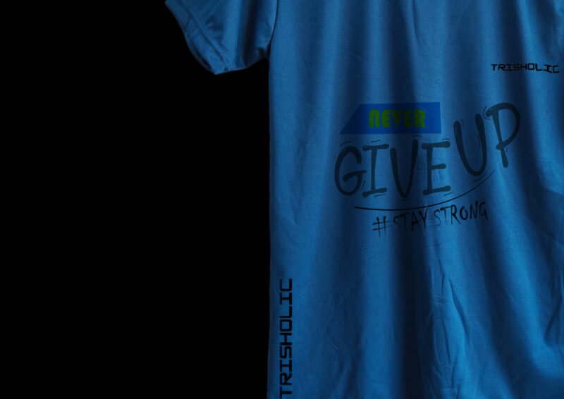 Close-up of “Never Give Up” print on matte blue cotton t-shirt