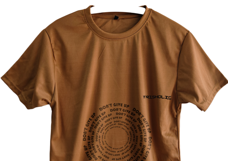Trisholic t-shirt with the word “Be Relentless” in bold, uppercase type centered across the chest.