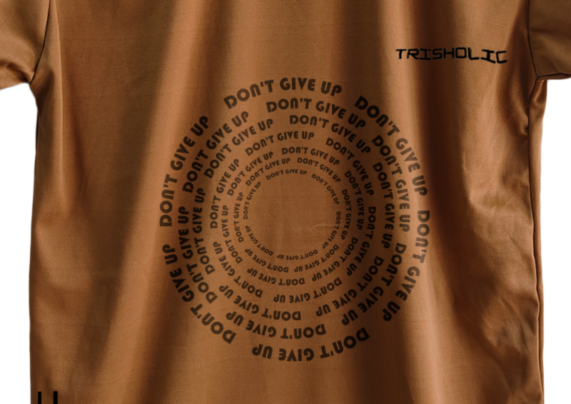 Minimalist white Trisholic shirt with the quote “Discipline Over Motivation” in sharp black type.
