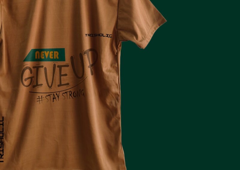Stack of folded peach color Trisholic t-shirts