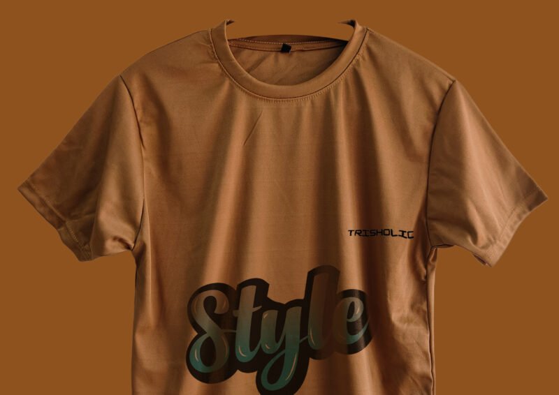 Stack of folded peach color Trisholic t-shirts
