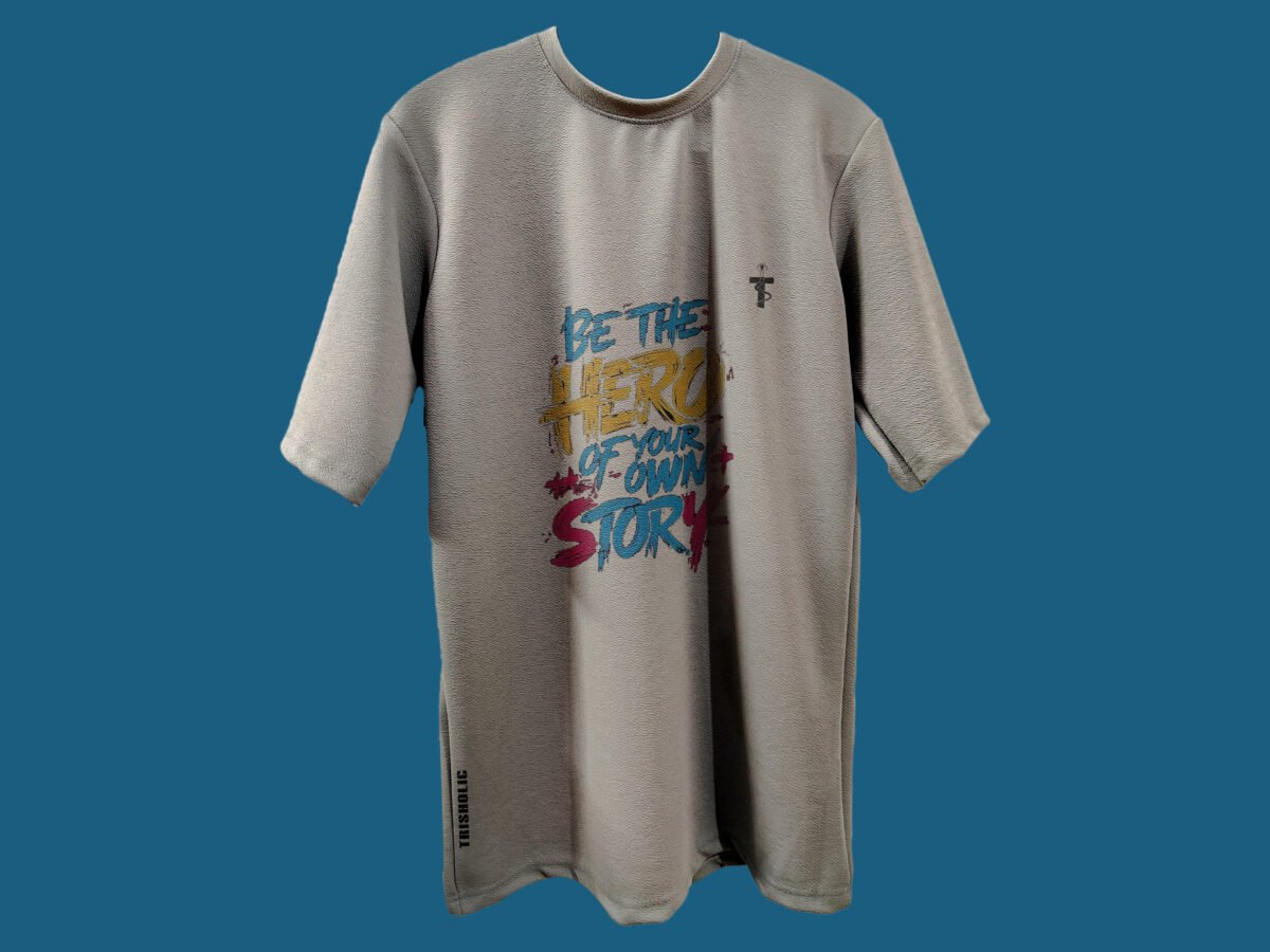 Flat lay of Be the Hero quote t-shirt by Trisholic