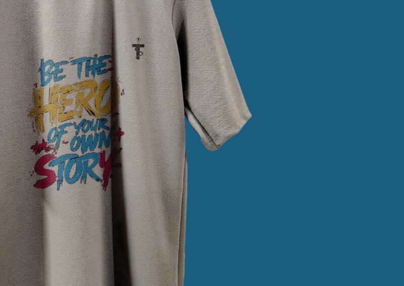 Model wearing Trisholic oversized Be the Hero quote t-shirt