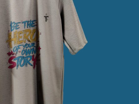 Model wearing Trisholic oversized Be the Hero quote t-shirt