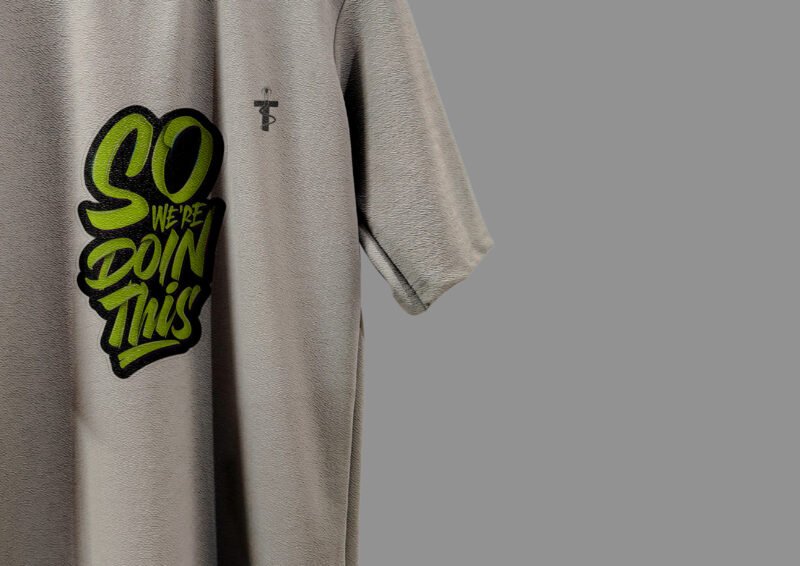 Backside view of grey Trisholic drop shoulder tee