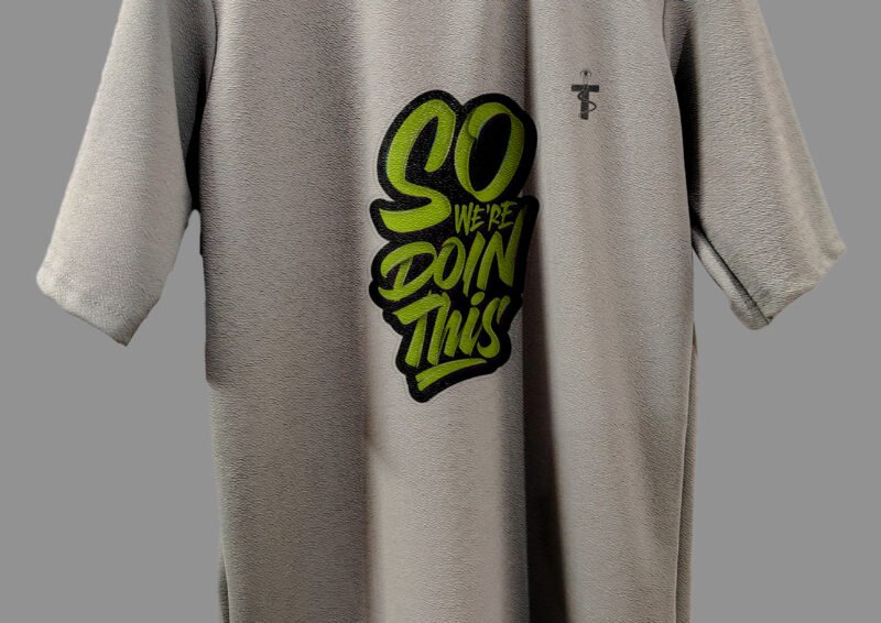 Side pose of a model wearing the Trisholic grey quote tee