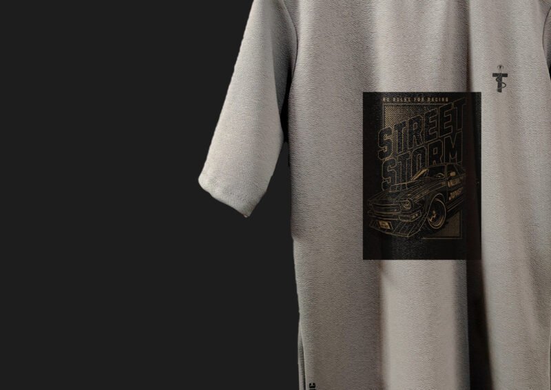 Flat lay of grey Street Storm tee with chains and sunglasses