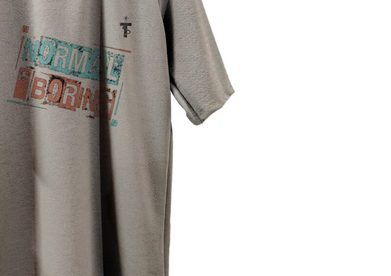 Flat lay of oversized grey Normal Is Boring t-shirt