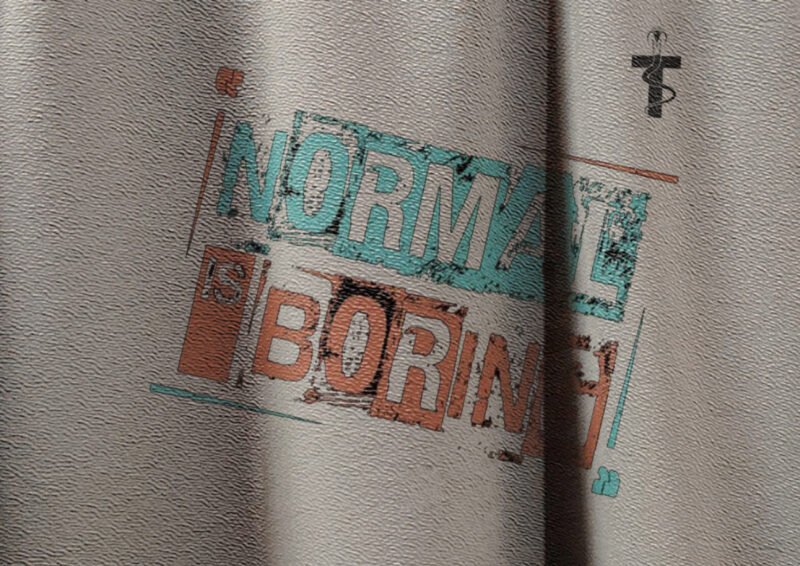 Close-up of Normal Is Boring quote on t-shirt