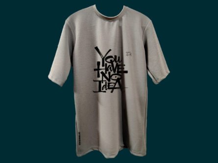 Model Sitting in Outdoor Scene Wearing Grey Tee