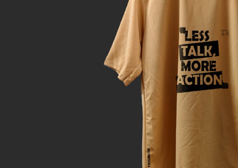 Lifestyle Photo of Model Wearing Tee Against Urban Wall