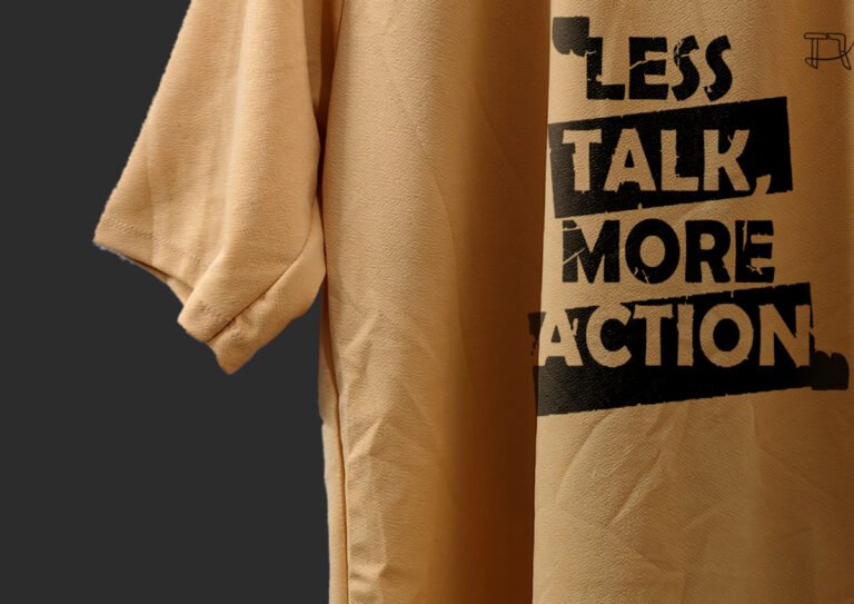 Flat Lay of Folded Peach T-Shirt with Printed Quote Visible