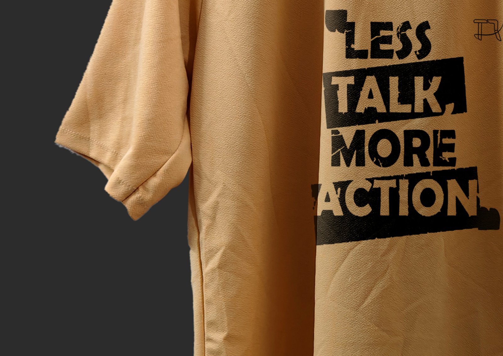 Flat Lay of Folded Peach T-Shirt with Printed Quote Visible